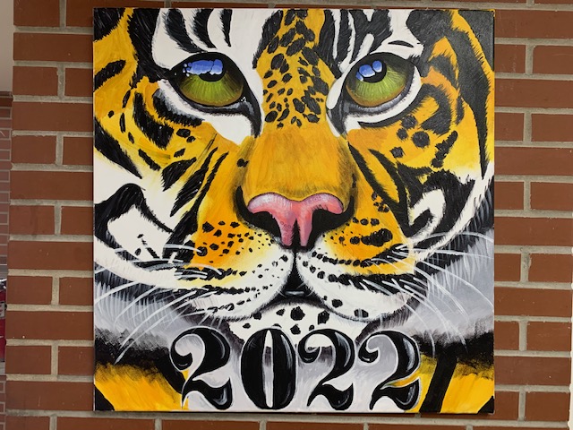 What we enjoyed about this piece is the vibrant colors and attention to detail. This is located at the top of D hall on the right side, created by Adrianna F.
