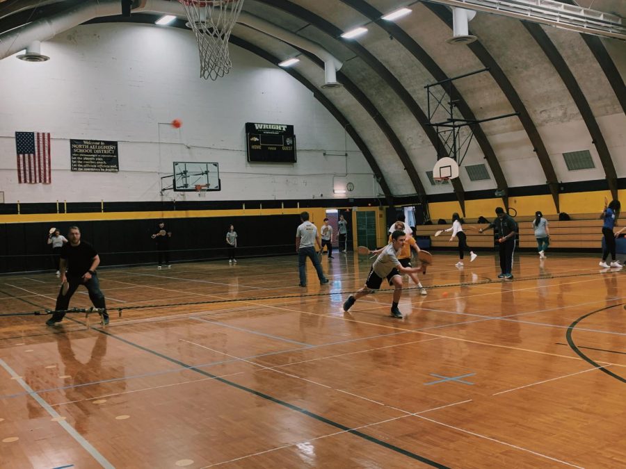 Mr. Love's 8A gym class getting active by playing an exciting game of pickleball.  