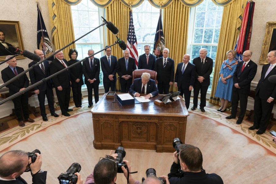 President Trump signs the CARES Act into law on March 27, 2020.