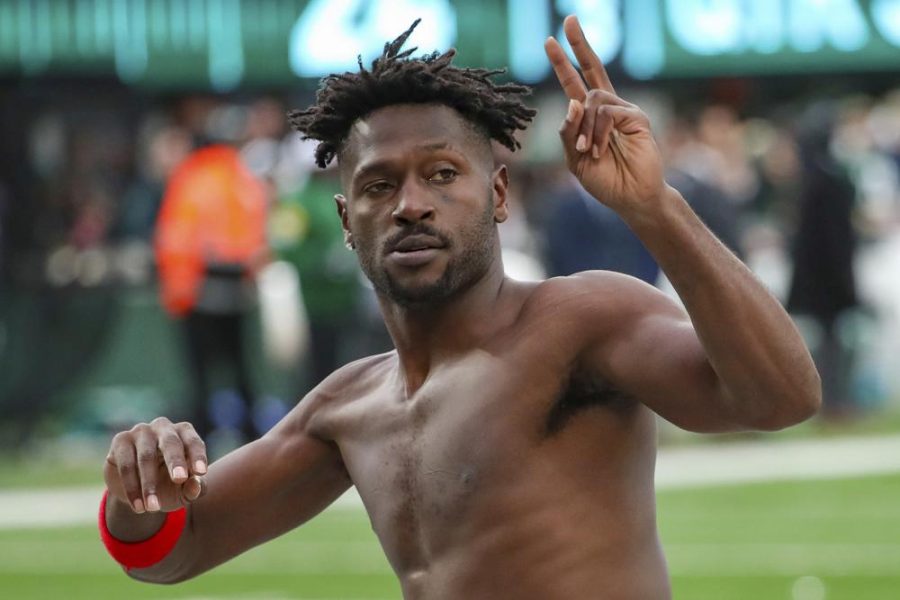 Tampa Bay Buccaneers wide receiver Antonio Brown gestures to the crowd as he leaves the field while his teams offense is on the field against the New York Jets.