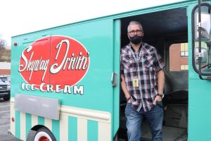 Greg Geibel poses with his Skyway Drivin Ice Cream Truck outside NAI.