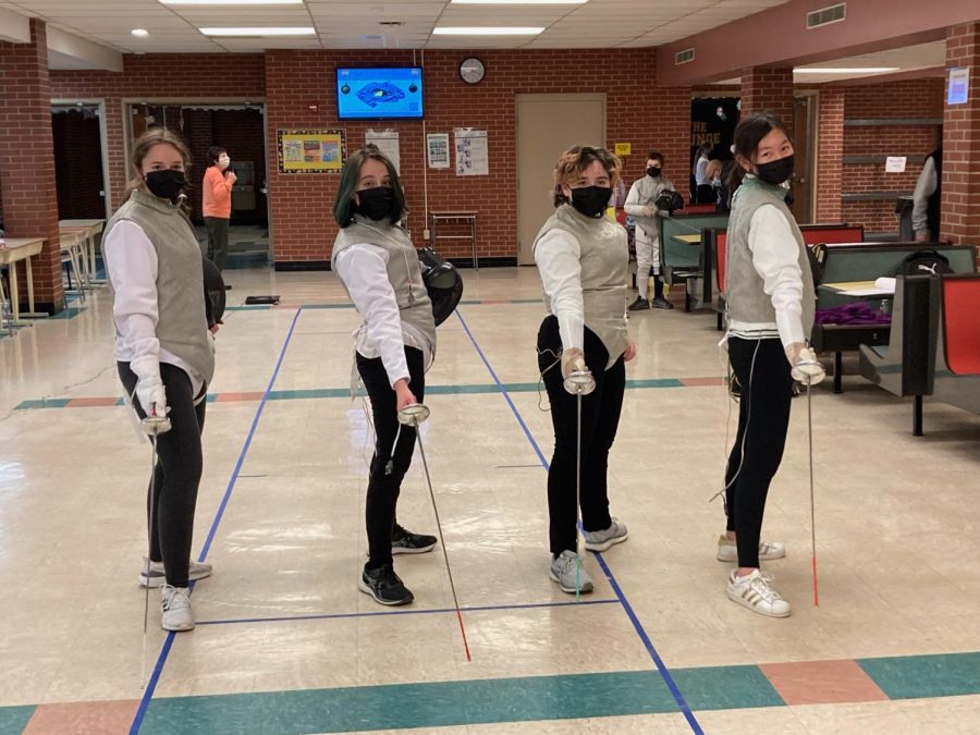 Members of the NA Girls Fencing Team practice in the NAI Cafeteria on Feb. 22, 2022.