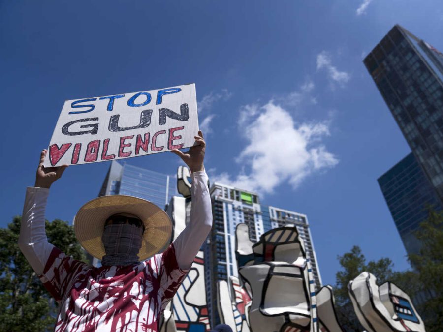 HOUSTON, TX - MAY 27: Gun control advocates hold signs during a protest at Discovery Green across from the National Rifle Association Annual Meeting at the George R. Brown Convention Center, on May 27, 2022 in Houston, Texas. The NRA kicked off its annual convention in Houston on Friday, days after 19 students and two teachers died in a shooting in Uvalde, Texas. (Photo by Eric Thayer/Getty Images)