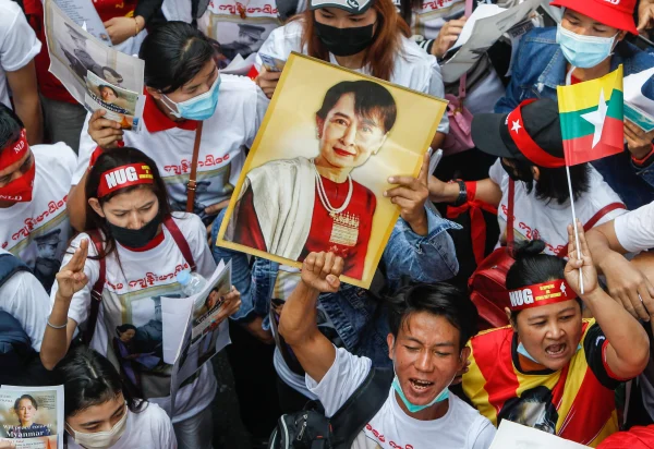 The people of Burma protesting in the street demanding that the military government to back down. 